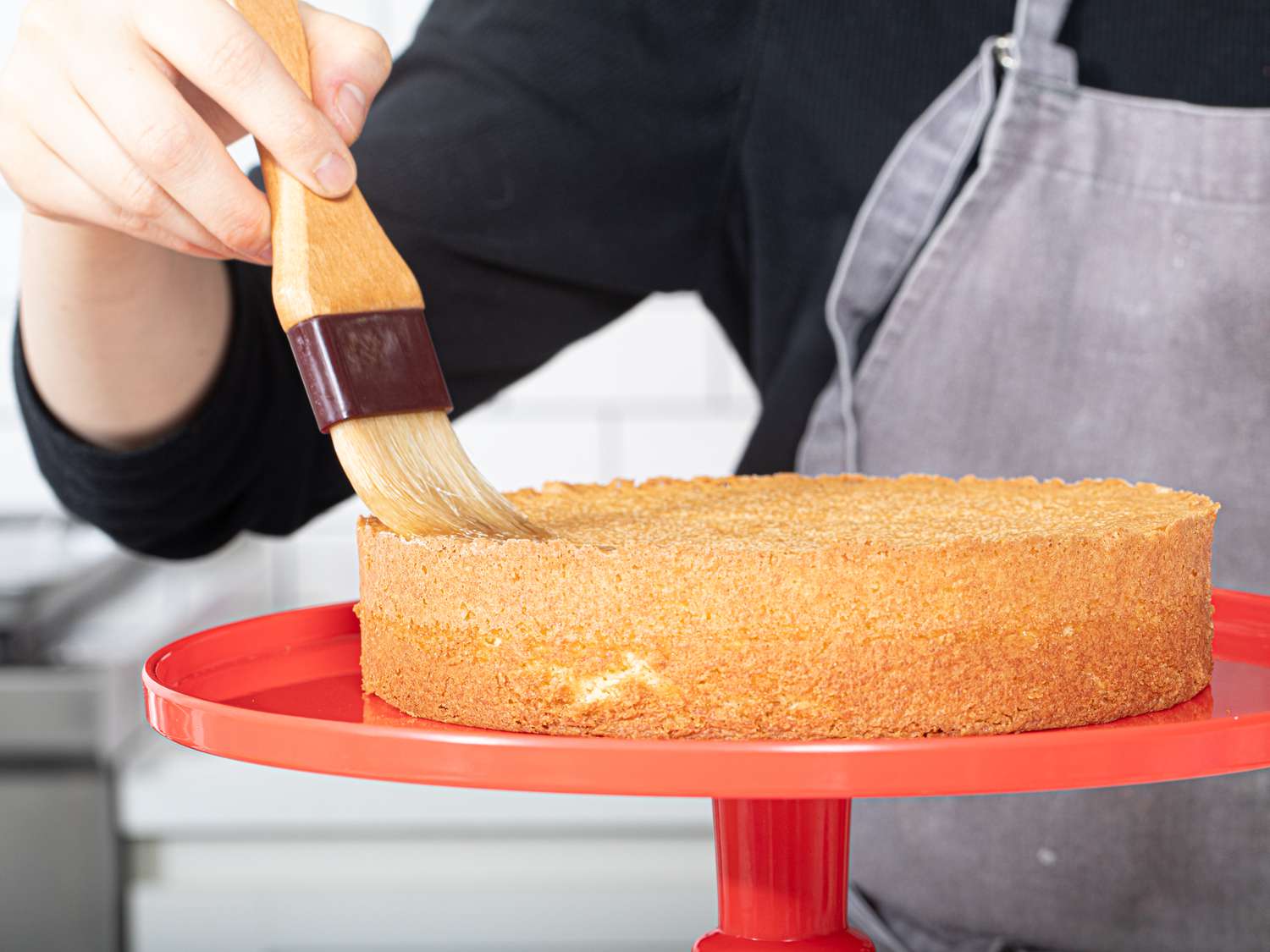 Brushing cake with syrup