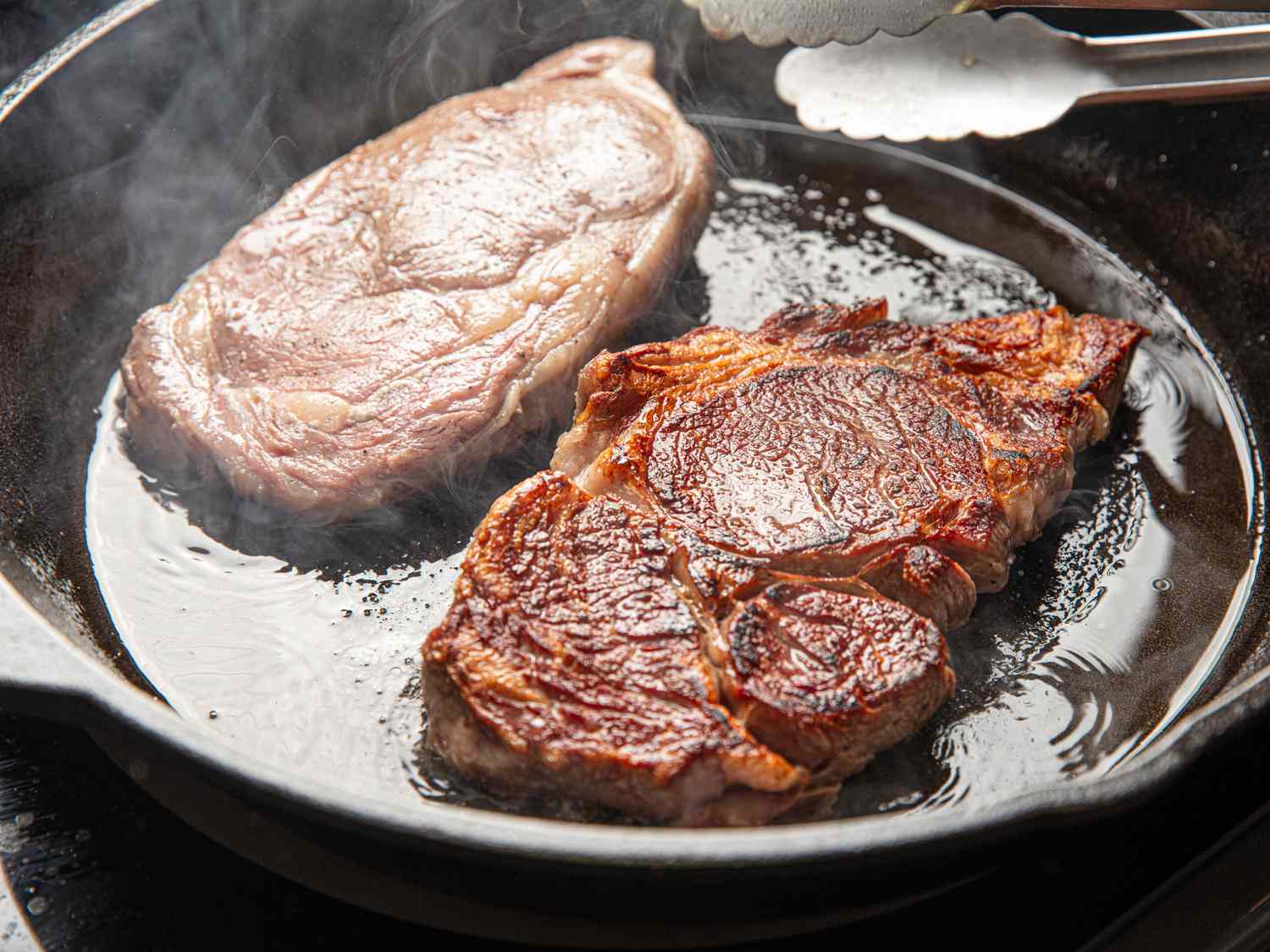 Two steaks in a cast iron pan