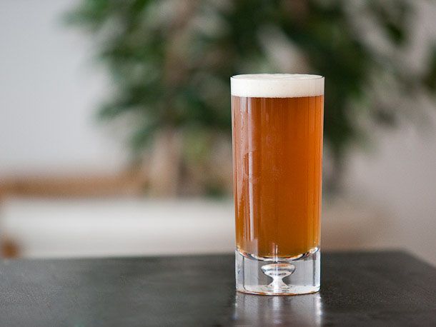 A glass of American Pale Ale on a counter top. 