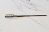 The OXO skewers on a marble kitchen countertop.