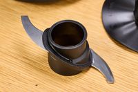 The blade on the KitchenAid Go Cordless 5-Cup Food Chopper on a wooden table