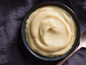 A bowl of homemade creamy banana pudding on a dark background