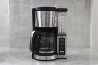 A Ninja CE251 12-Cup Coffee Brewer with a carafe, water reservoir, and control panel, displayed on a kitchen counter