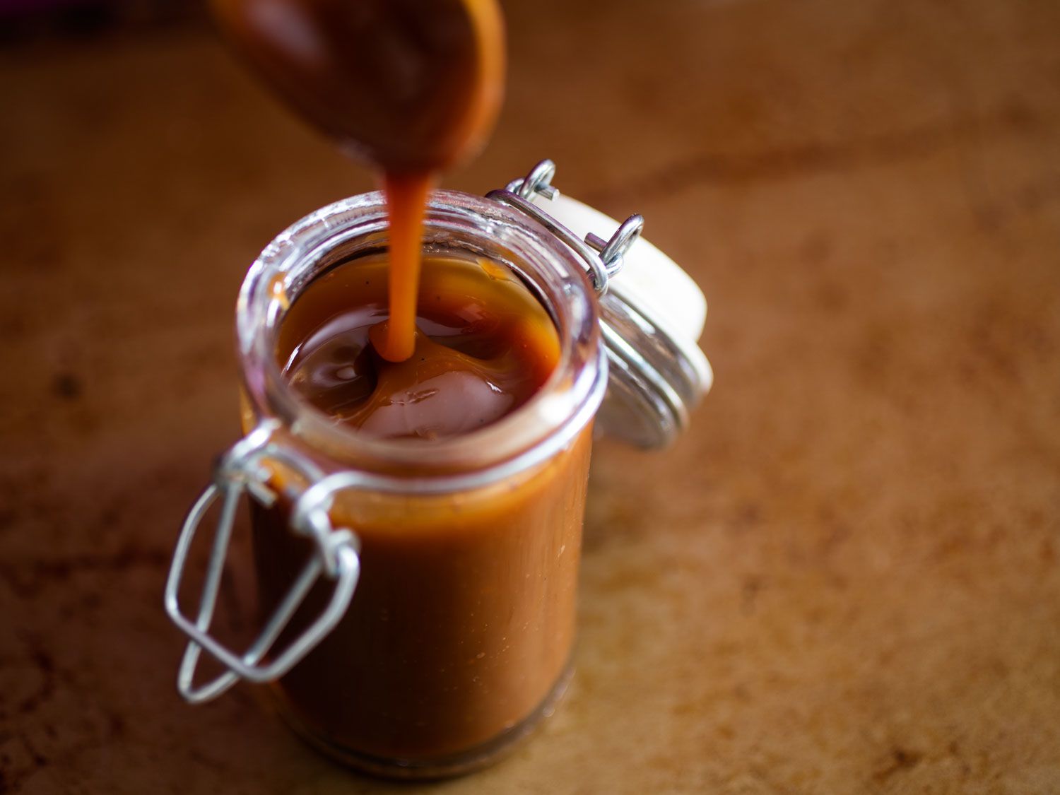 Cajeta dripping into a jar.