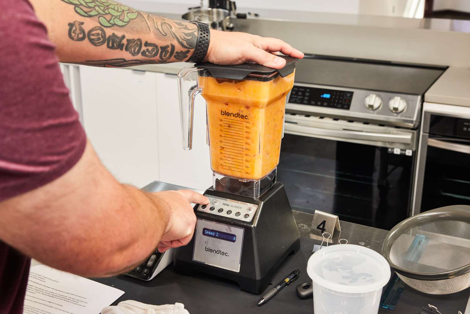 The Blendtec Total Blender Classic 75 oz blends orange liquid