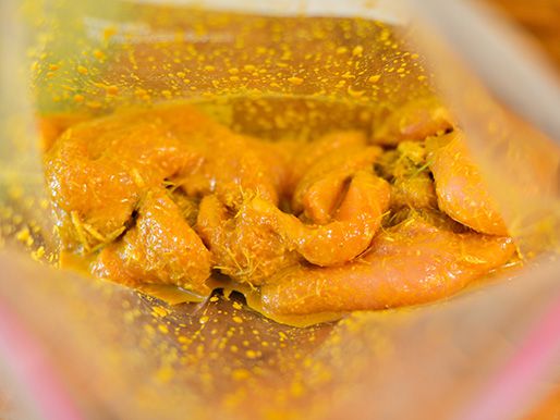 Chicken in a resealable bag being marinated.