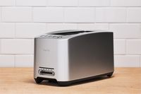 Breville BTA820XL Die-Cast 2-Slice Smart Toaster on a wooden counter
