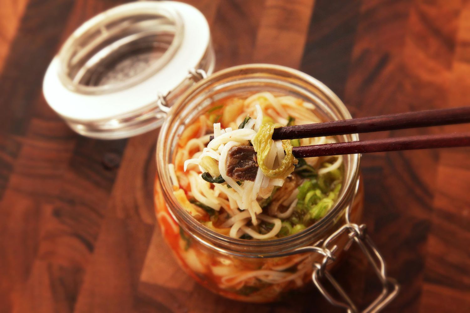 Spicy kimchi beef flavor instant noodles in a clip top jar.