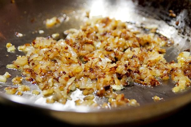 Chopped onions browning and caramelizing in a skillet
