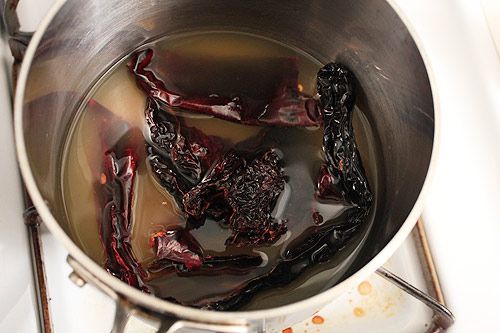 Simmering dried chiles in chicken broth