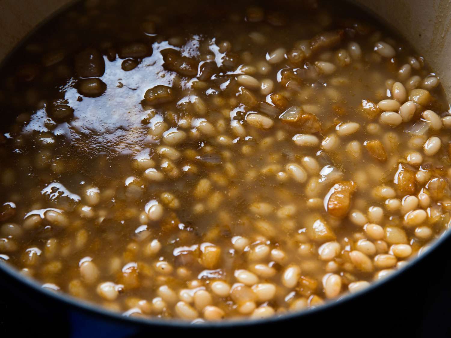 Photograph showing the proper amount of liquid to add to Dutch oven of beans for Boston baked beans.