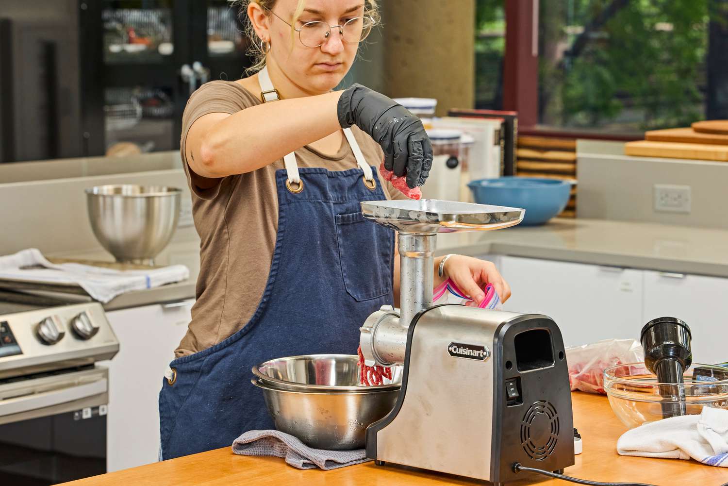 Person placing meat in food tray of Cuisinart Electric Meat Grinder