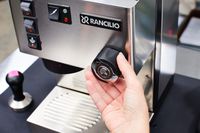 Closeup of a hand turning a knob on the Rancilio Silvia Espresso Machine 