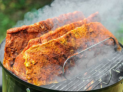Checking on ribs in a smoker.