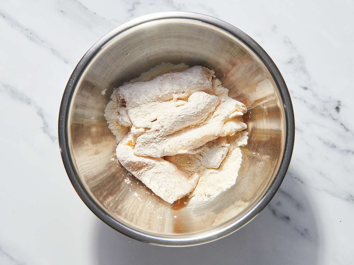 Overhead of fish coated in flour