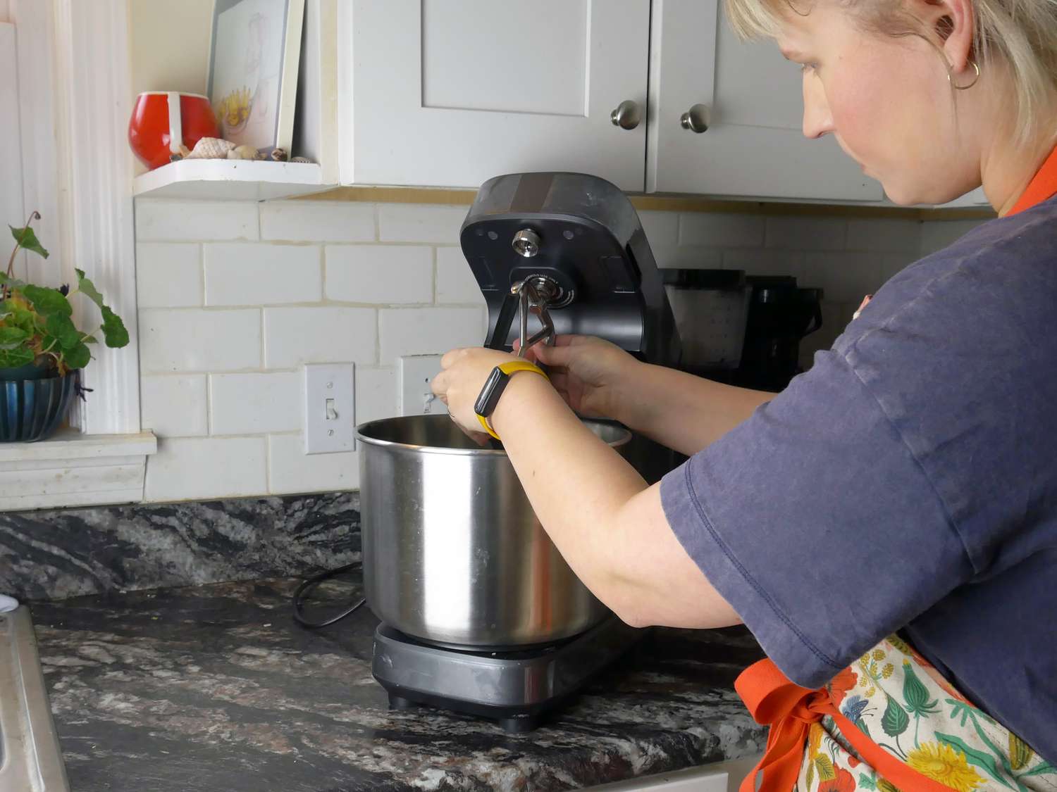 a person placing an attachment in the ooni