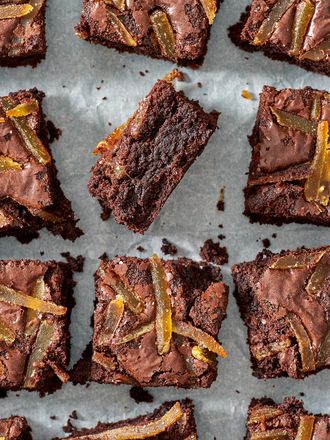 Ginger spiced brownies laid out on a slice of parchment paper.