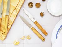 made in steak knives on a white tile surface