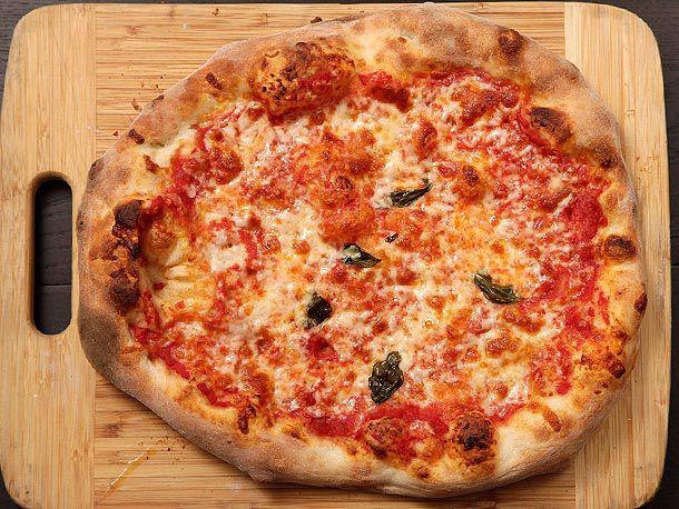 A pizza on a wooden cutting board