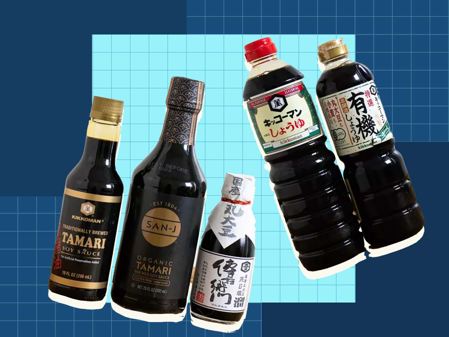 Different brands of soy sauce in bottles on a blue grid background