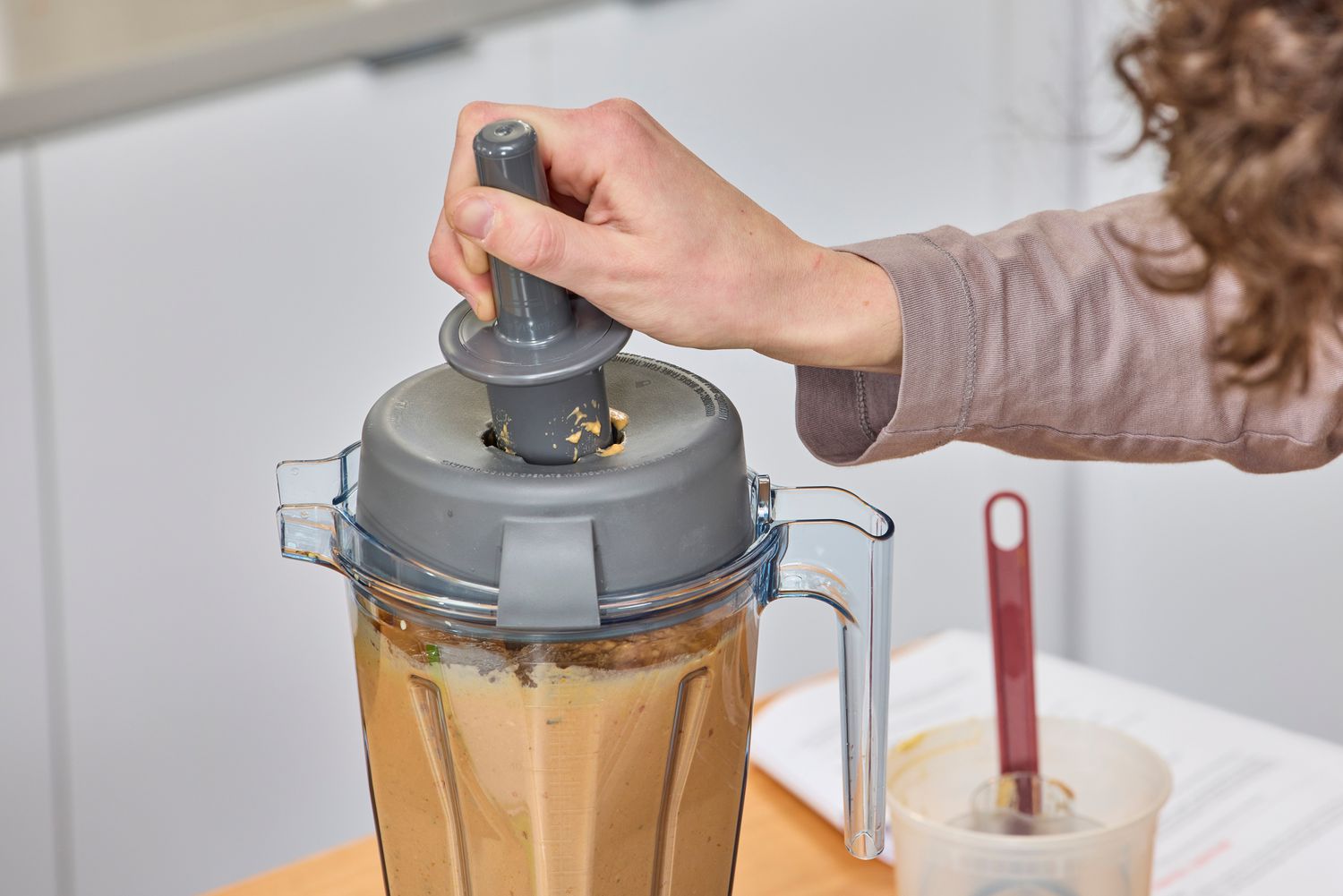 A person using an accessory of the Vitamix Propel 510