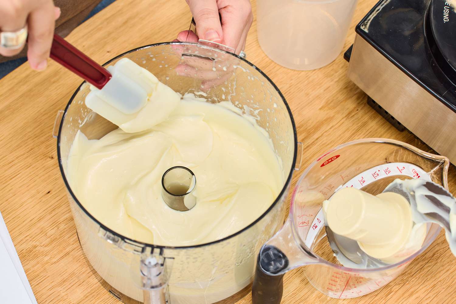 A person stirs food pureed in the Cuisinart 14-Cup Food Processor