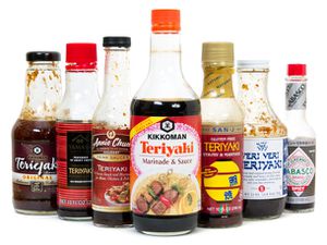 Seven bottles of different brands of teriyaki sauce