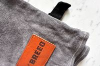 The brand name printed on a patch on the Breeo Fire Pit Gloves