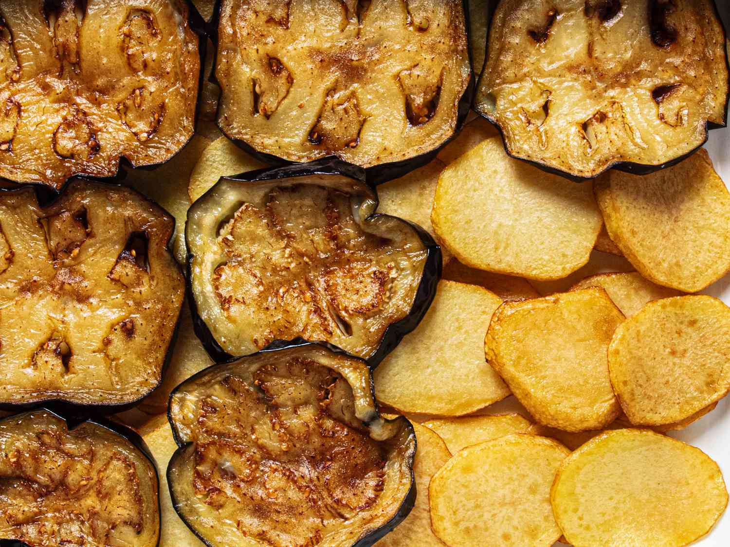 Close up image of eggplant layered on top of potatoes