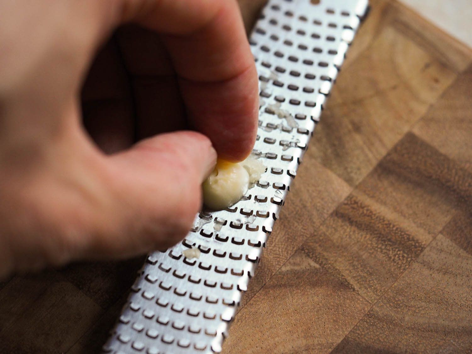 Grating garlic on a microplane.