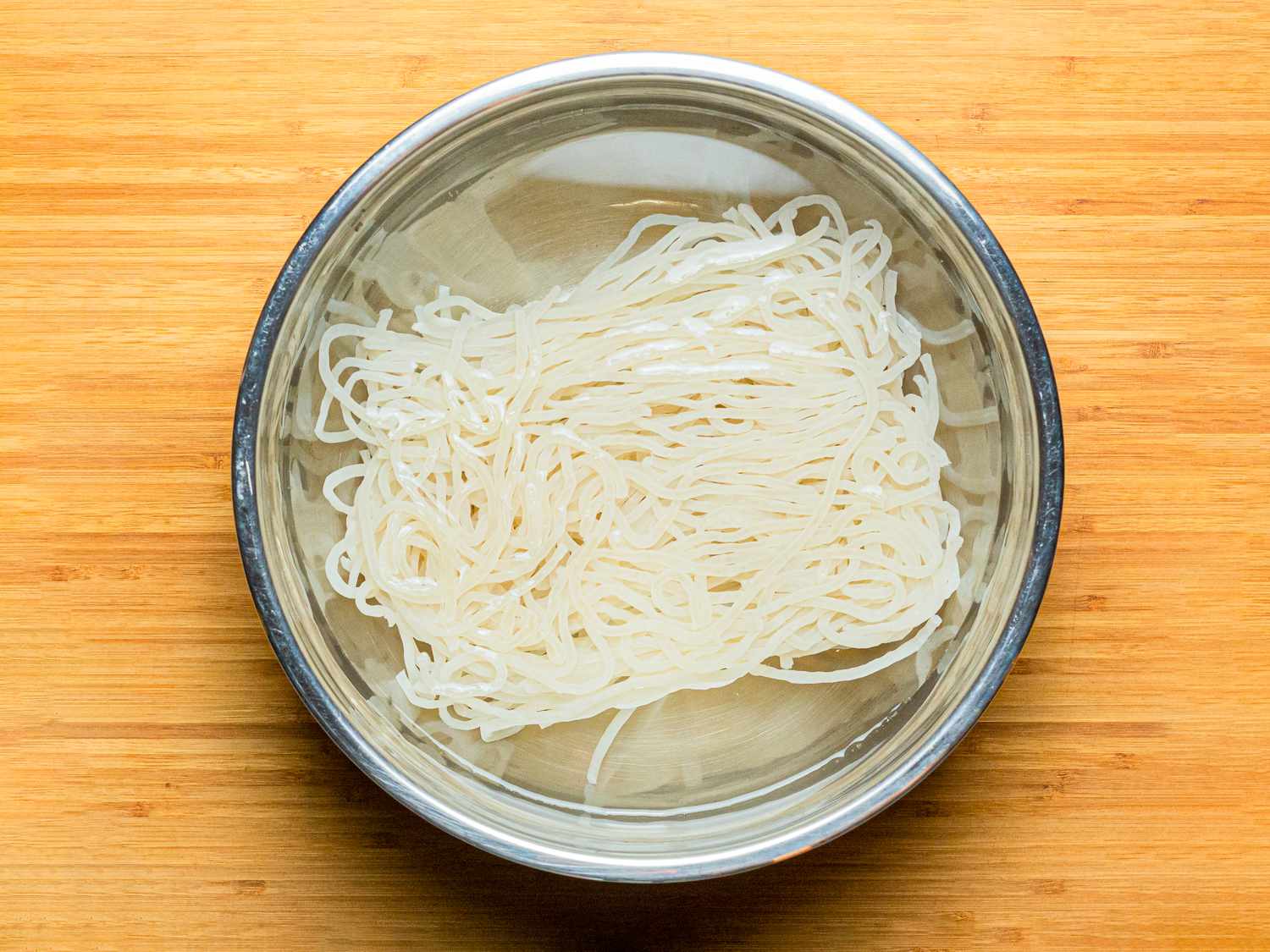 Overhead view of noodles soaking in water