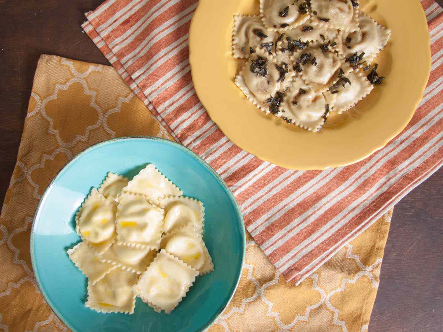 Two serving bowls of ravioli: ricotta-filled and butternut squash and blue cheese with a sage brown butter sauce.