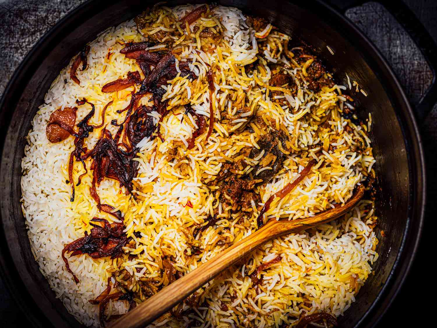 Overhead view of pot of lamb biryani
