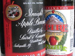 Two ingredients essential for a stone fence: a bottle of apple brandy and a bottle of hard cider.