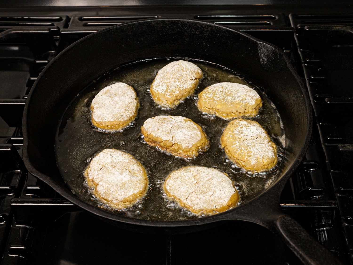 Overhead view of meat patties in skillet