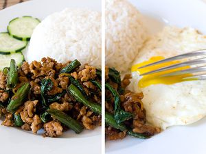 A plate of Thai basil chicken, gai pad krapow, with white rice, a fried egg, and sliced cucumbers. 