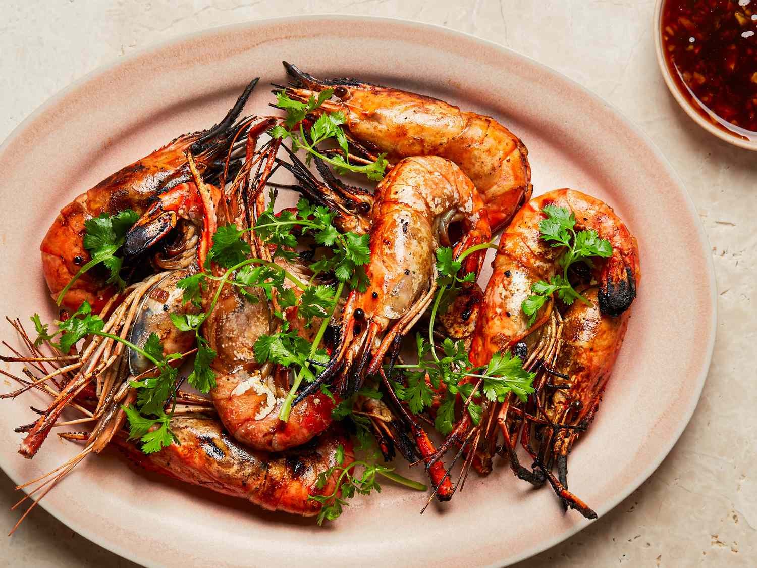 Grilled prawns with herbs and a side of sauce