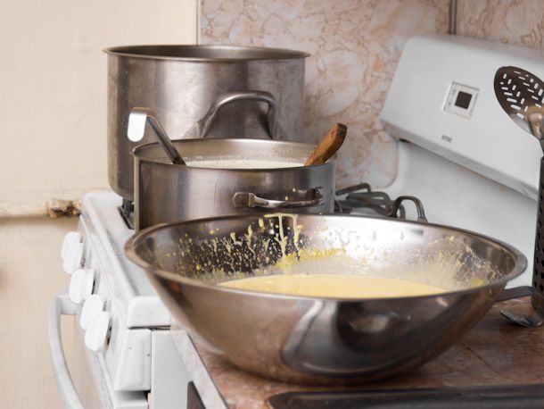 Ice cream custard in a large metal bowl on a counter.