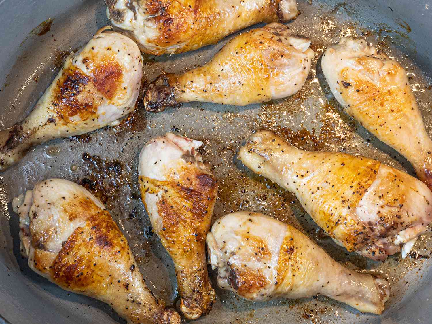 Chicken cooking in a Dutch oven.