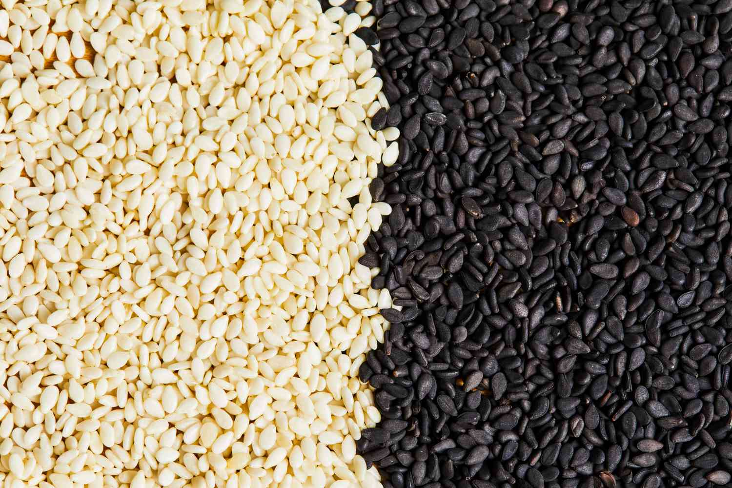 white sesame seeds next to black sesame seeds