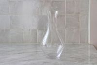 A closeup of the empty Riedel Cabernet wine decanter on a marble counter