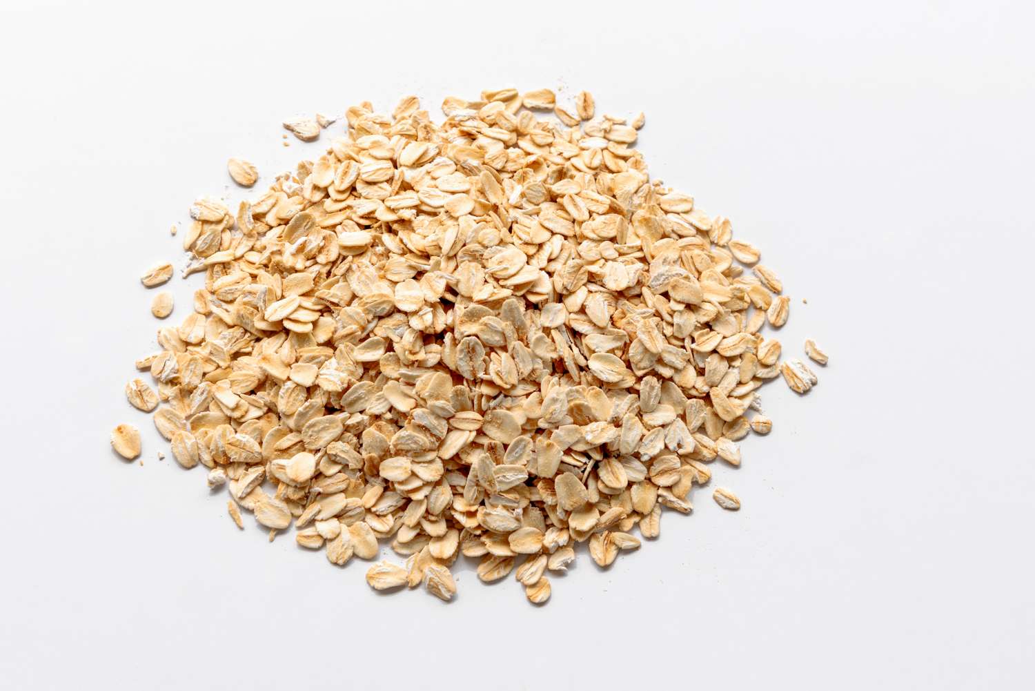 A pile of rolled oats on a white background