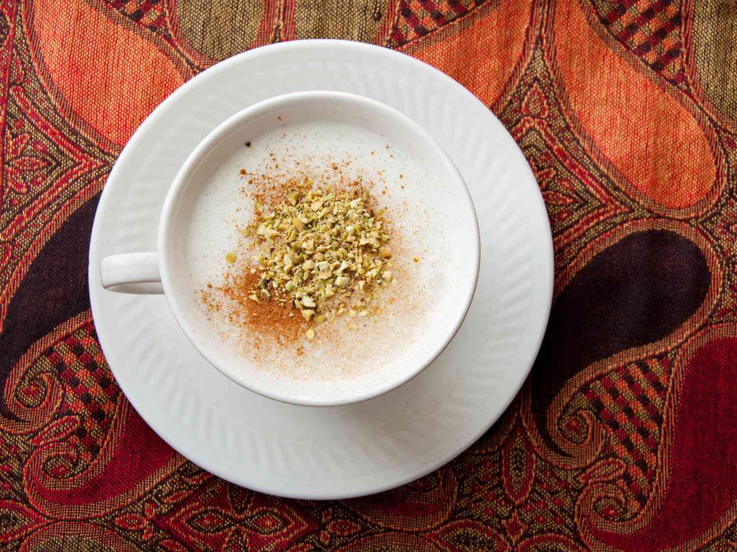 A cup of salep on a plate. 
