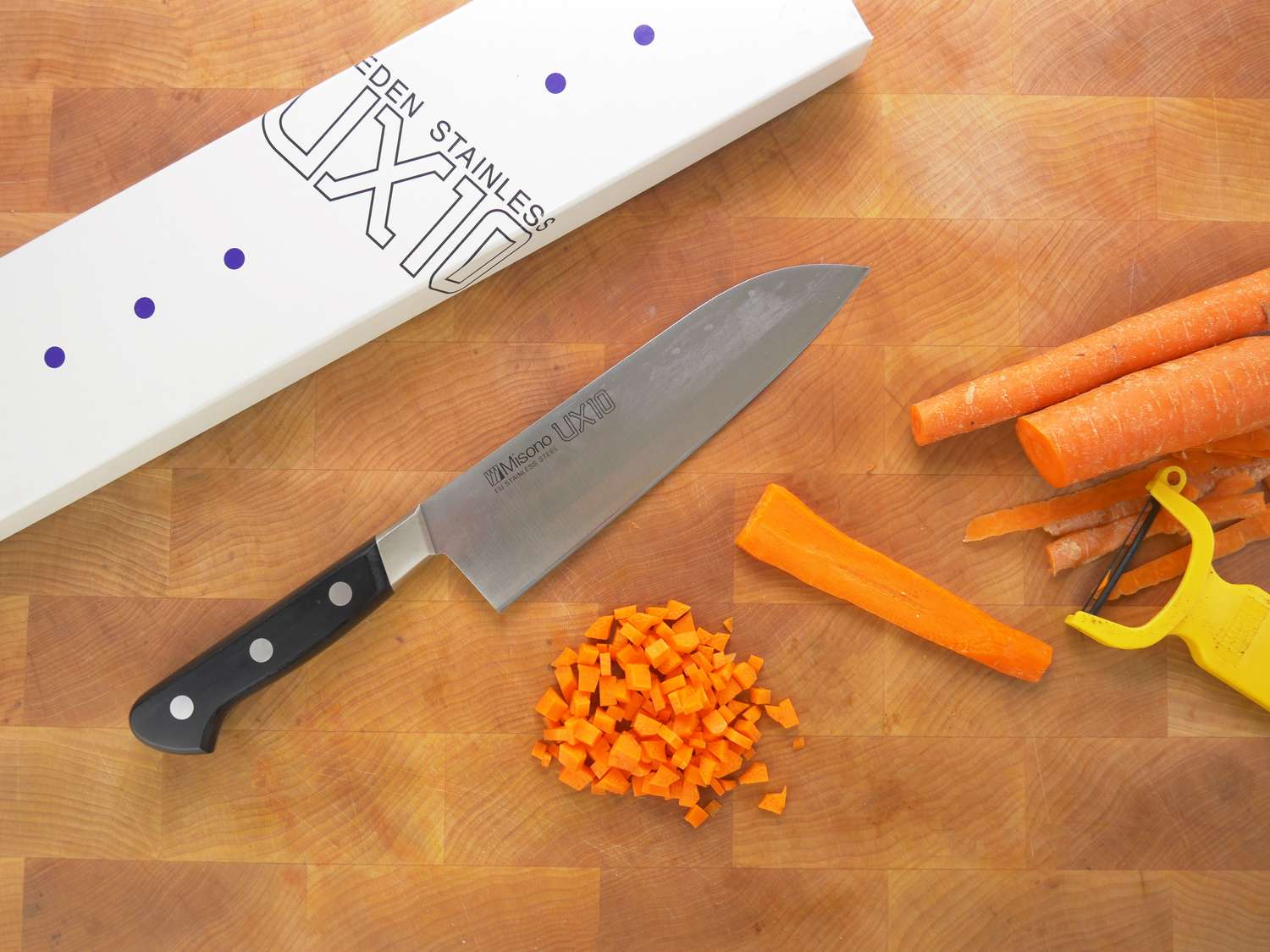 misono ux10 on a cutting board with the box and a cut up carrot