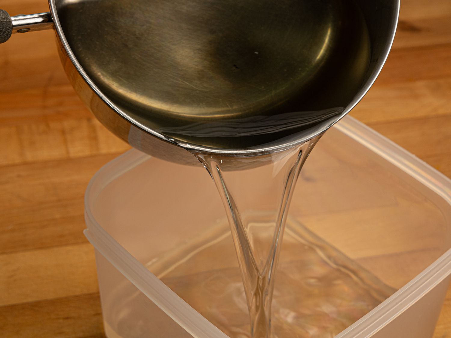 Side view of pouring syrup into a container