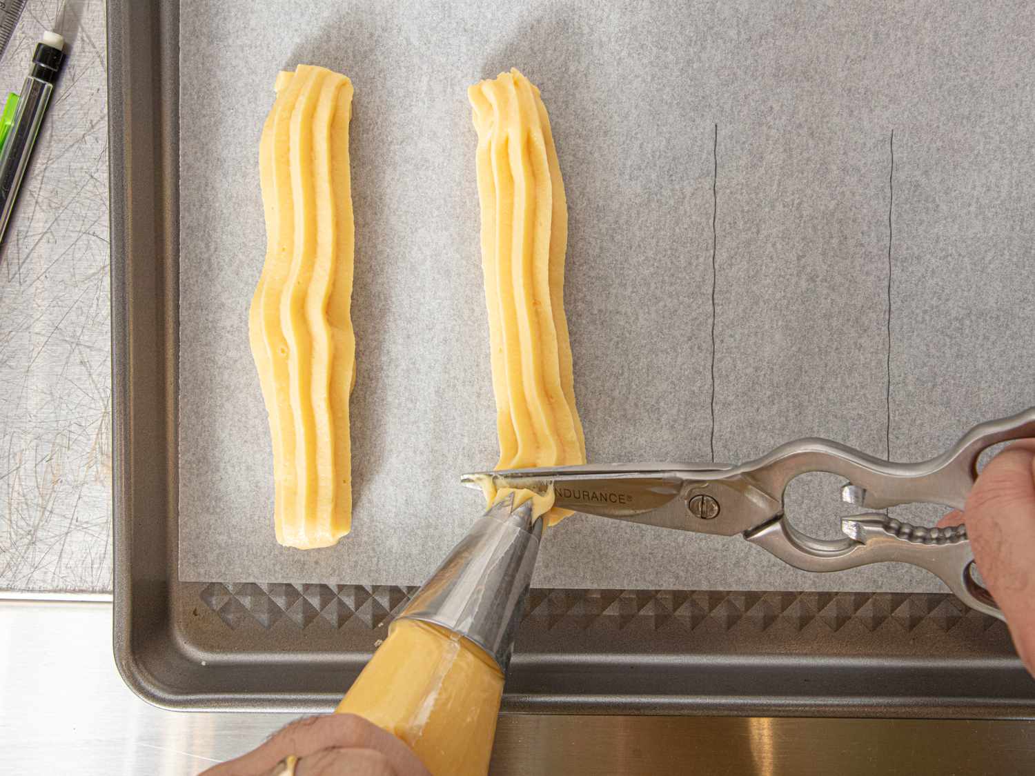 Piping churros onto parchment
