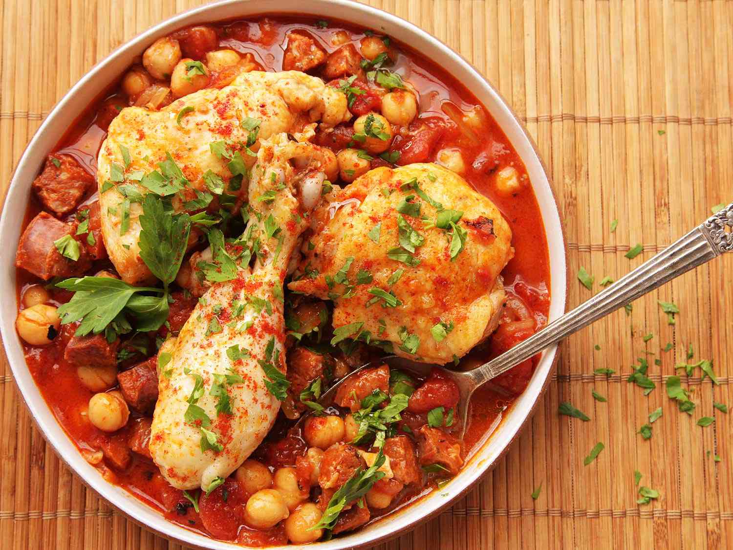 30-minute pressure cooker chicken with chickpeas, tomatoes, and chorizo, served in a shallow serving bowl.