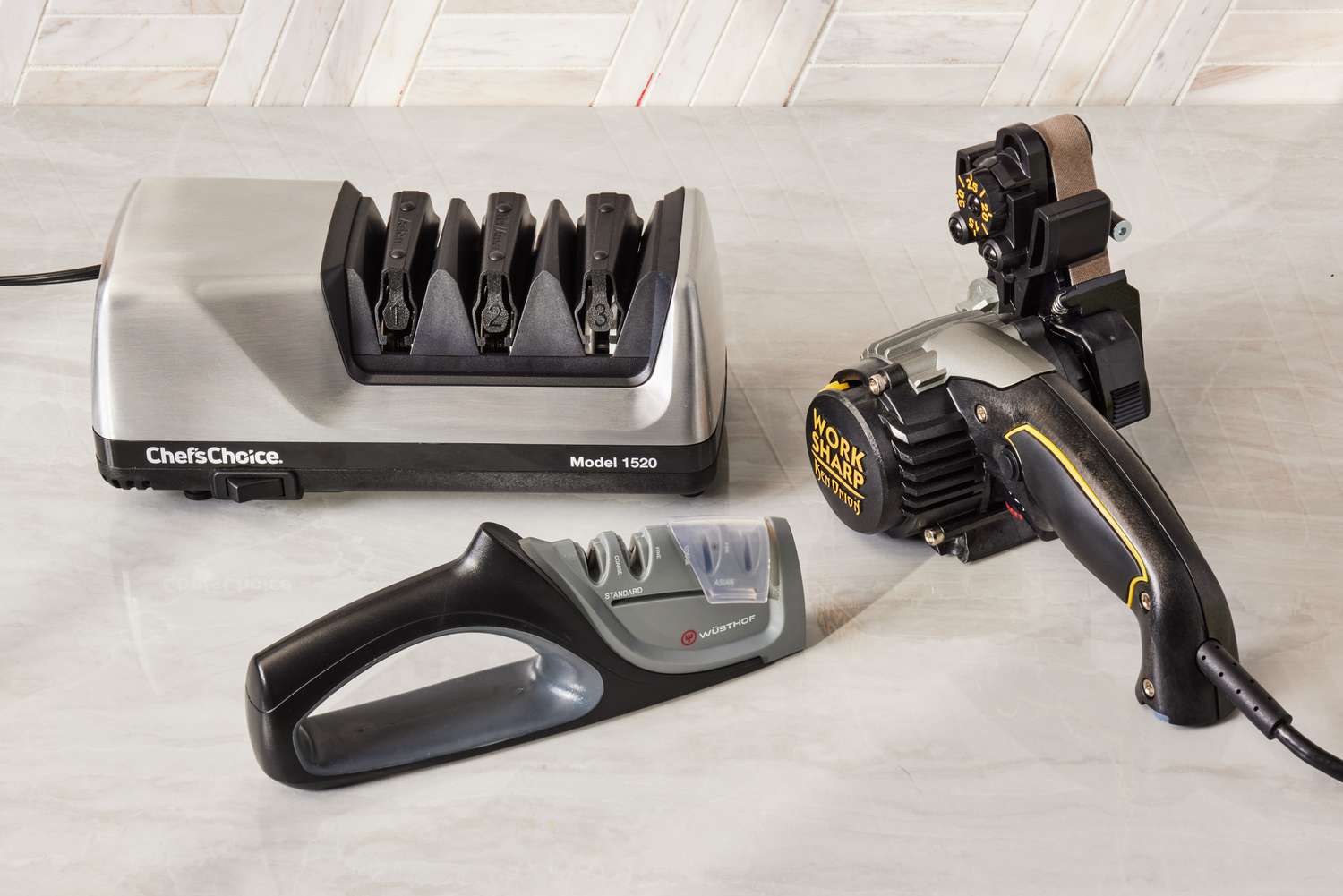 Three knife sharpeners sit on a countertop.