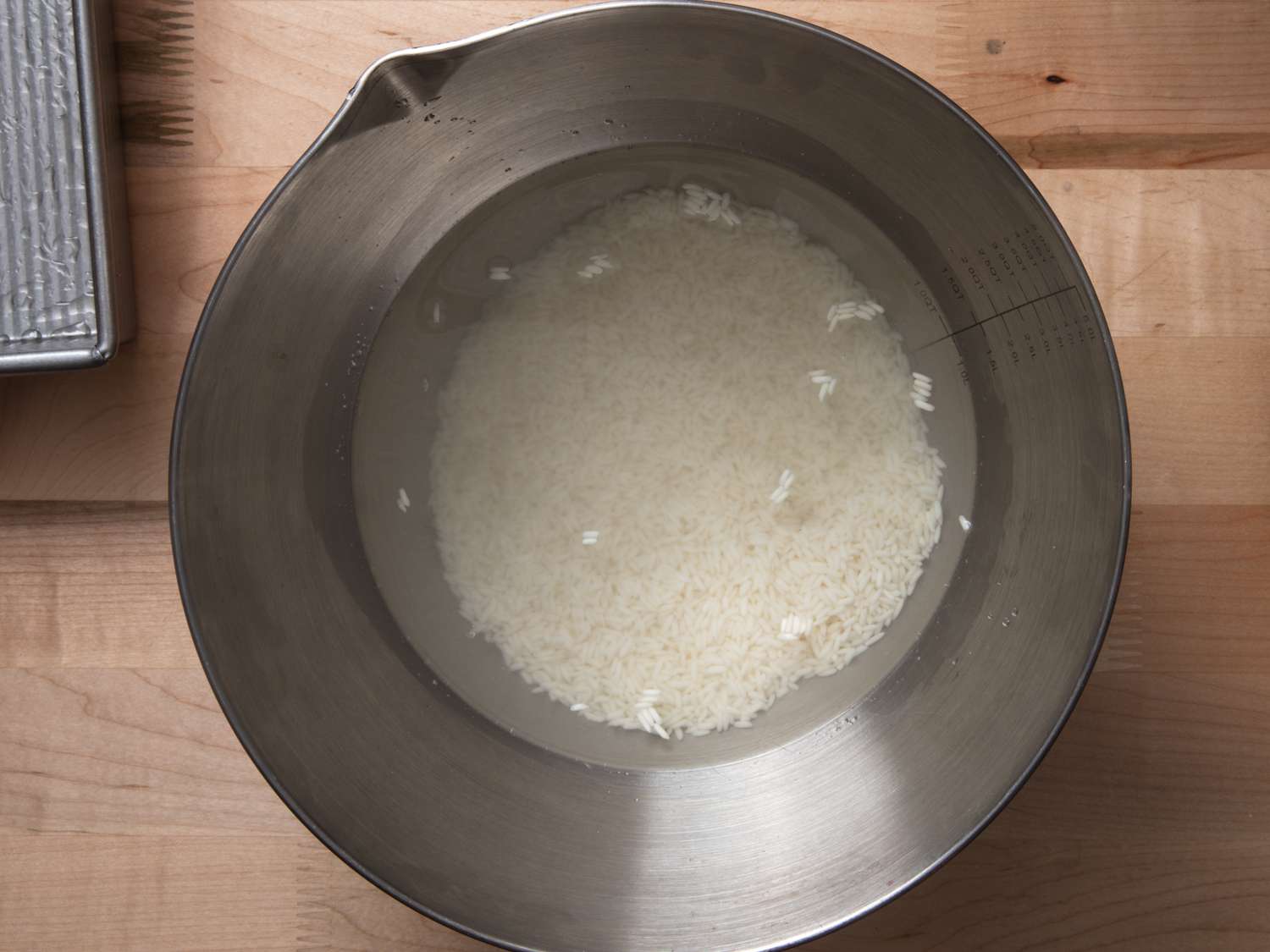washing rice in a metal bowl