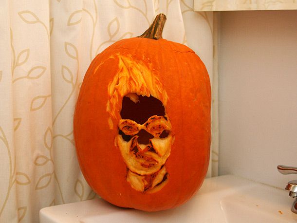 Finished design of a person's face carved into a pumpkin, without lighting